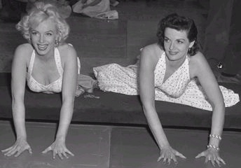 Marilyn Monroe and Jane Russell add their handprints to Grauman's Chinese Theater (Wikimedia Commons/Los Angeles Times)