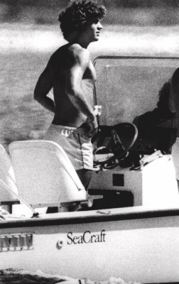 John F. Kennedy, Jr. son of the late president, spends a late summer day at the helm of a small power boat off the shore near his home in Hyannisport, Massachusetts, Sunday, Sept. l9, 1979. Come Monday, John will register as a freshman at Brown University in Providence, Rhode Island. (AP Photo)